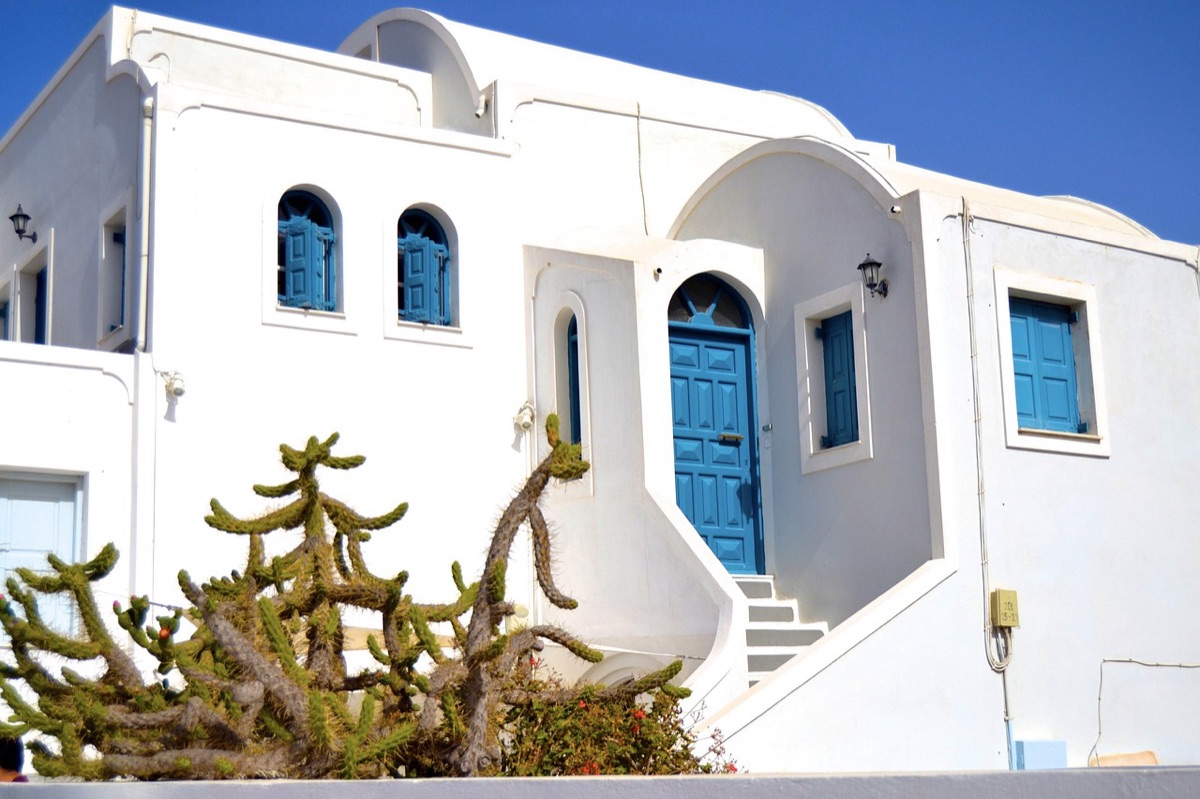 Greek tourist resort with white buildings and blue sea