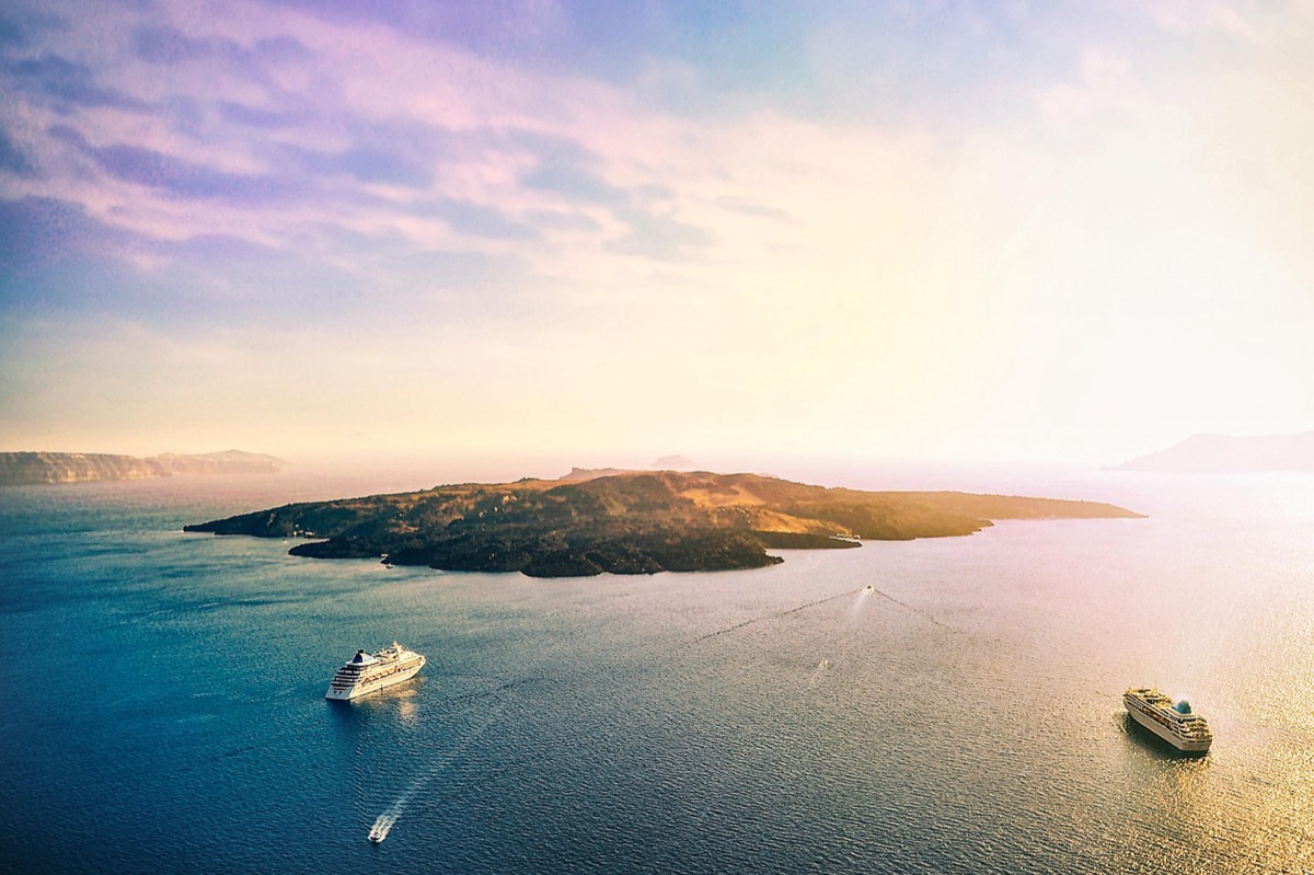 Santorini sunset with sea, golden light, Aegean Sea reflection