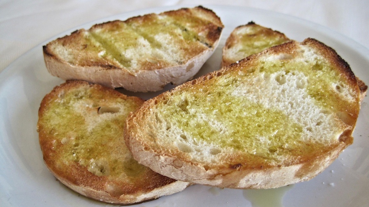 Stone table with olive oil and bread in a Santorini kitchen