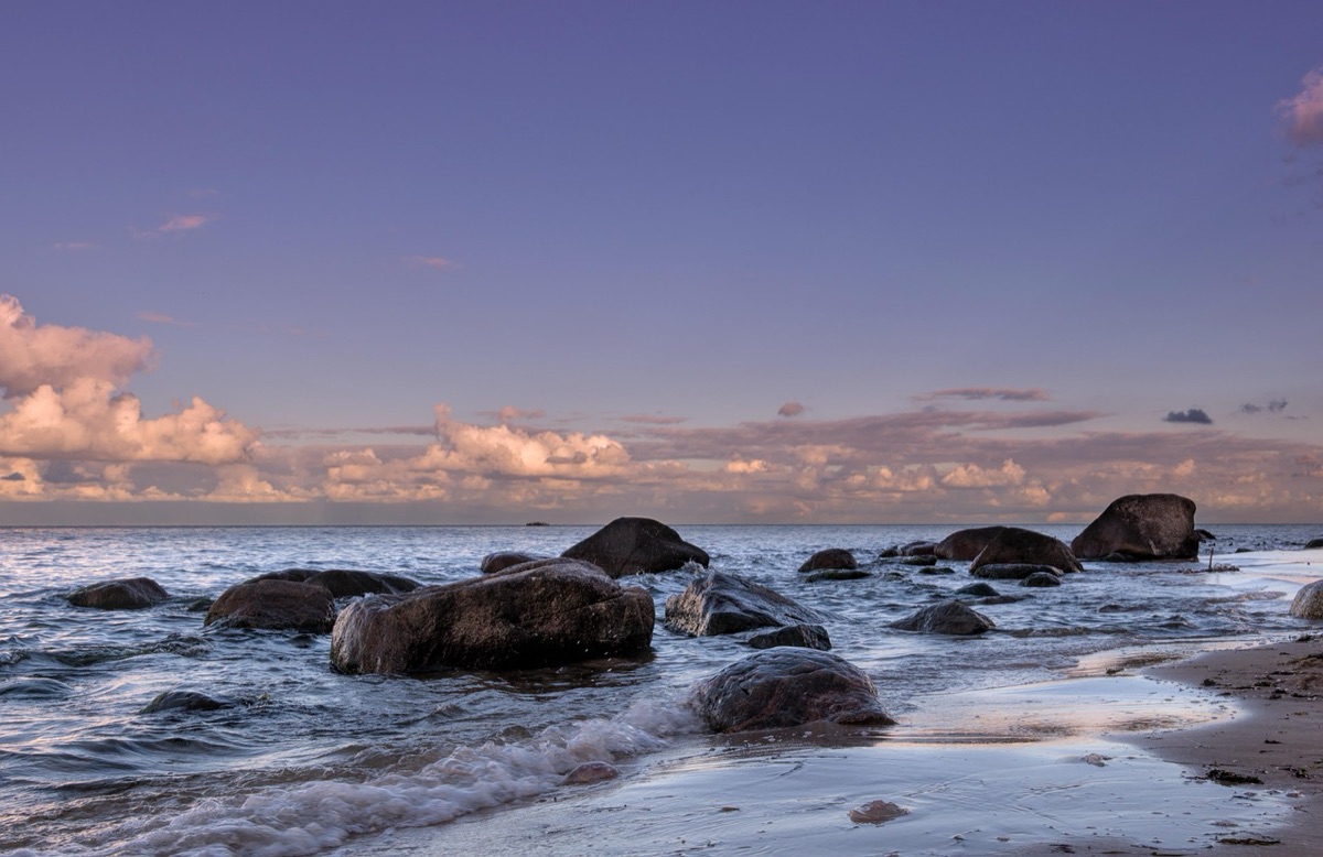 Sunset beach with rocks and sea